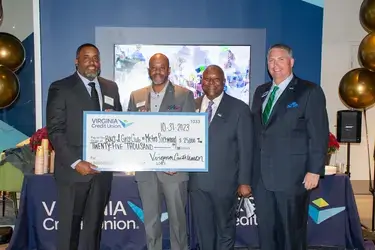 VACU presents check to celebrate new branch